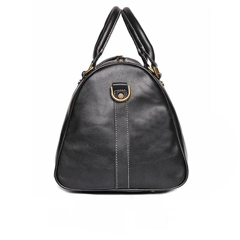 Black handbag with gold accents on a white background