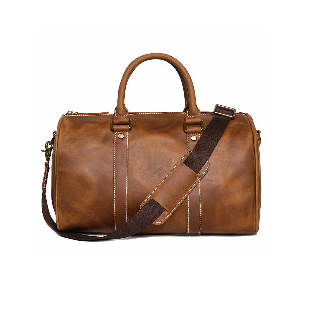 Brown leather duffel bag with a strap on a white background