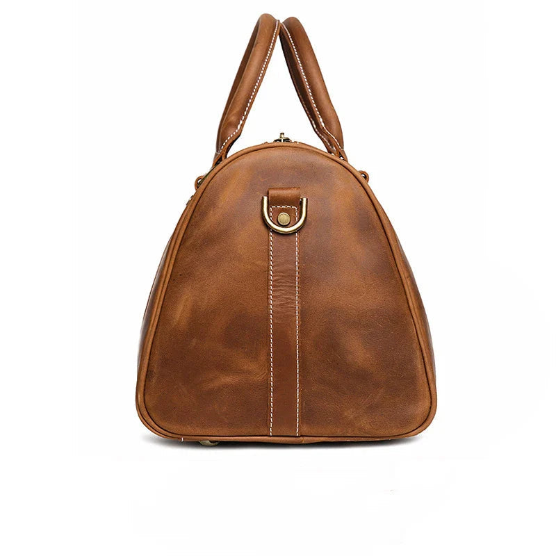 Brown leather handbag with gold clasp on a white background