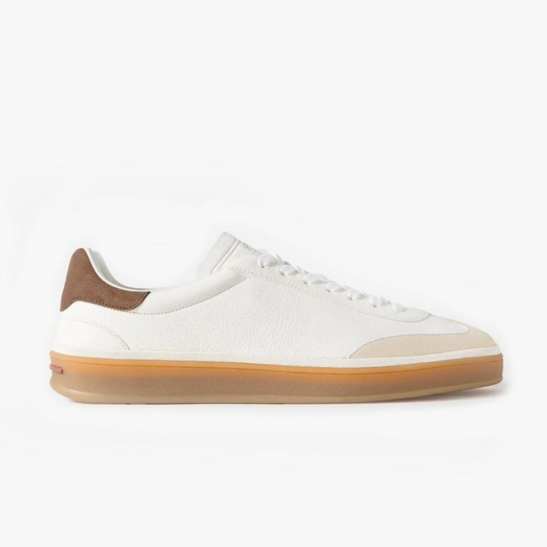 White sneaker with brown accents on a white background