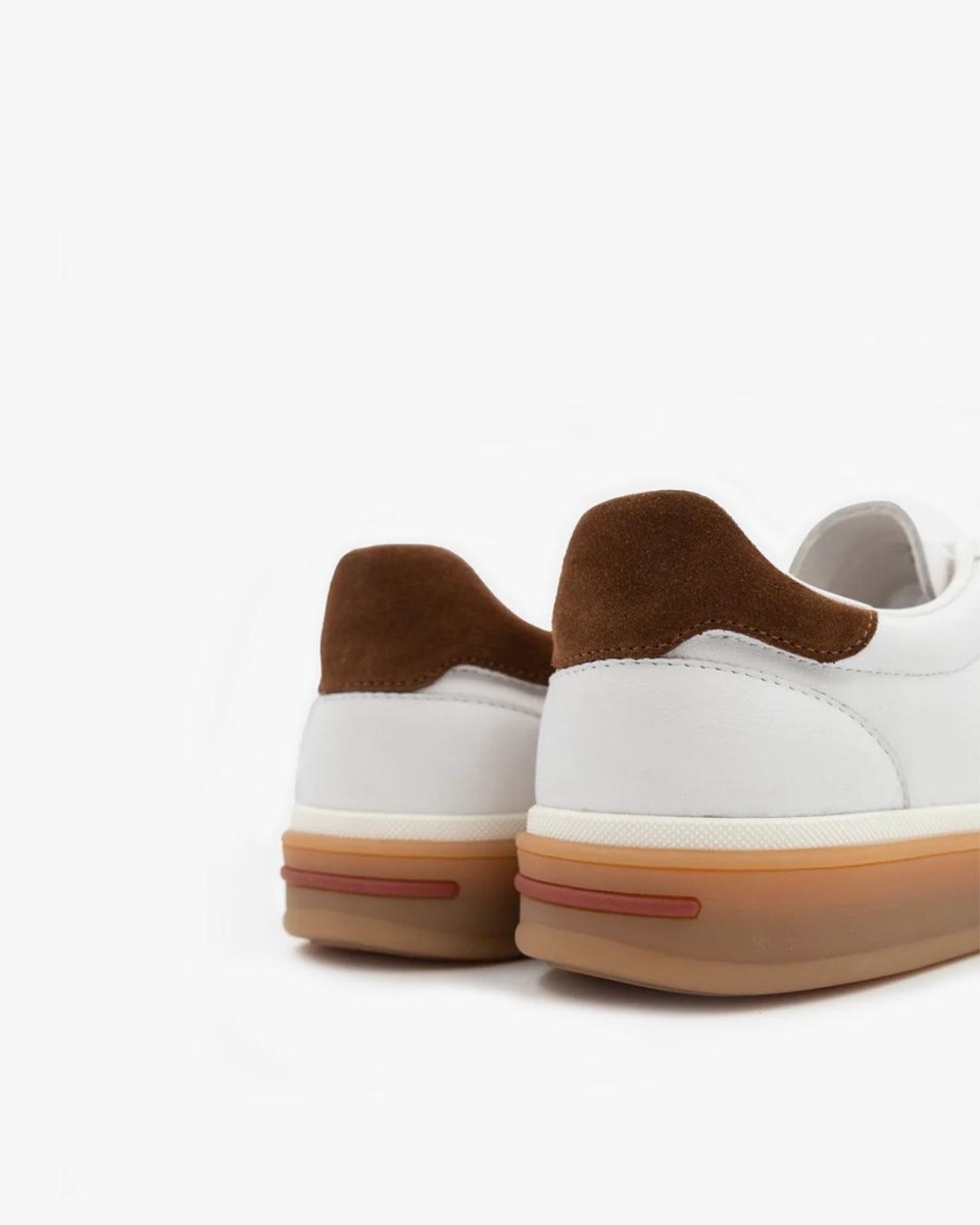 White sneakers with brown accents on a white background
