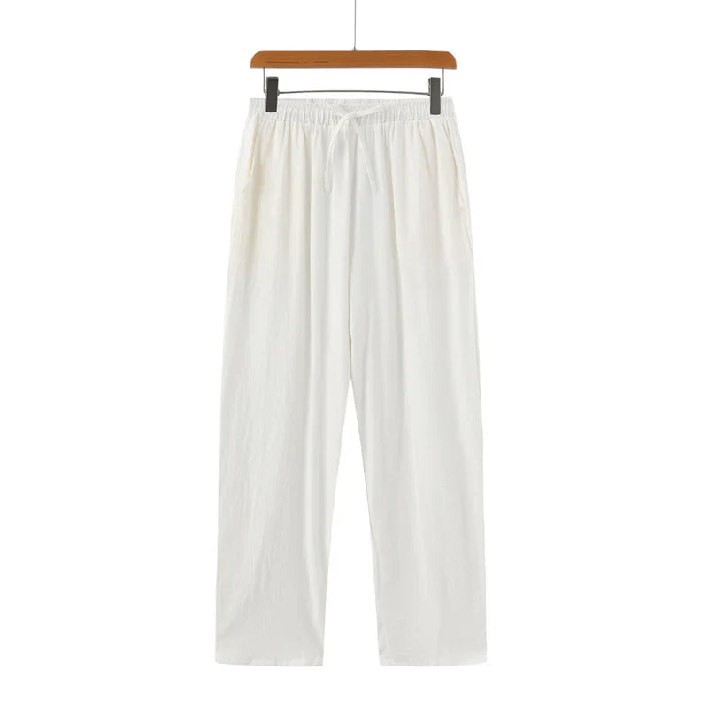 White pants on a hanger against a white background
