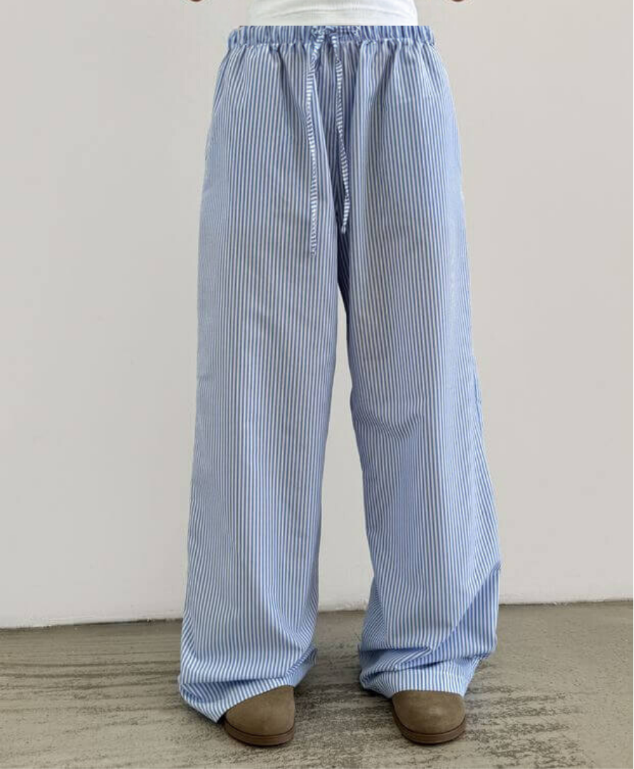 Blue and white striped pants on a neutral background