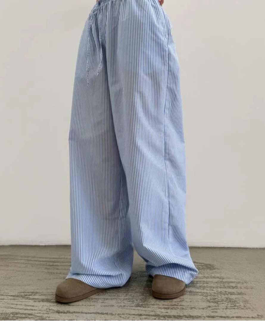 Light blue striped pants worn by a person on a neutral background