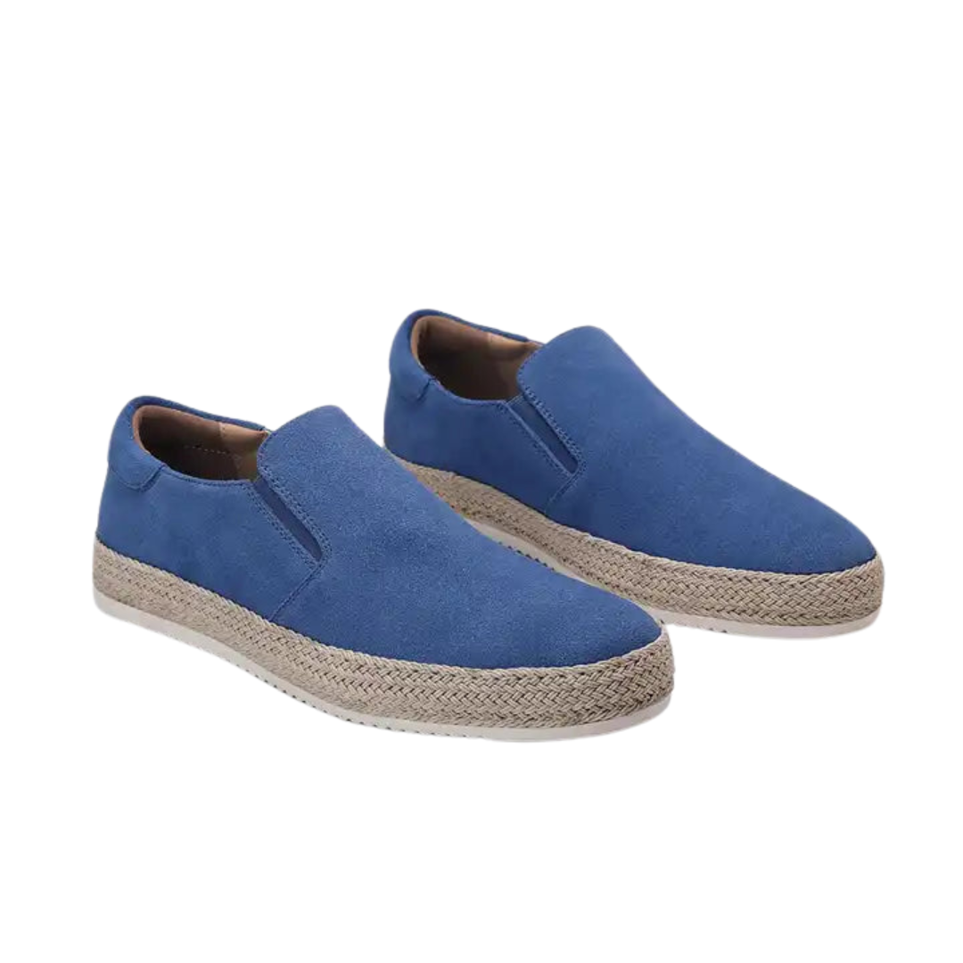 Pair of blue slip-on shoes with jute sole on a white background