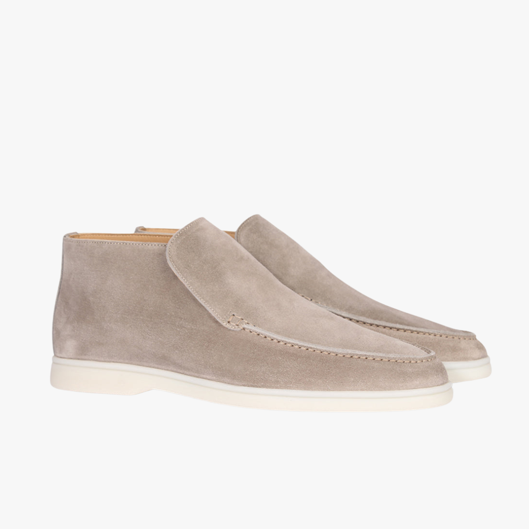 Pair of beige suede shoes on a white background