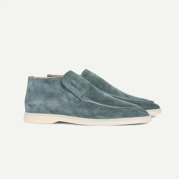 Pair of blue suede shoes on a white background