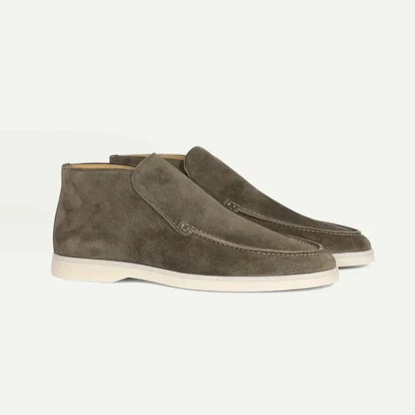 Pair of brown suede shoes on a white background