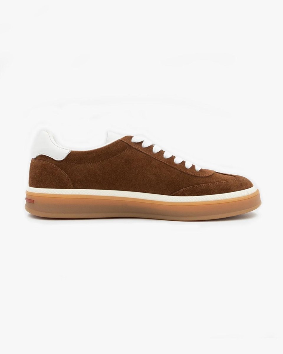 Brown suede sneaker with white laces and sole on a white background