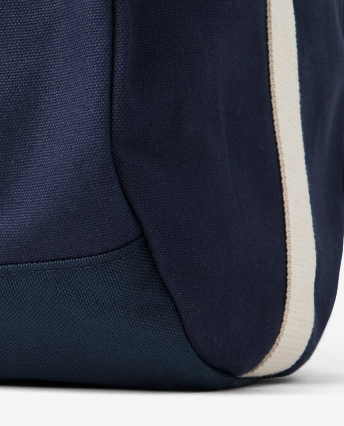Navy blue bag with a white stripe on a light gray background