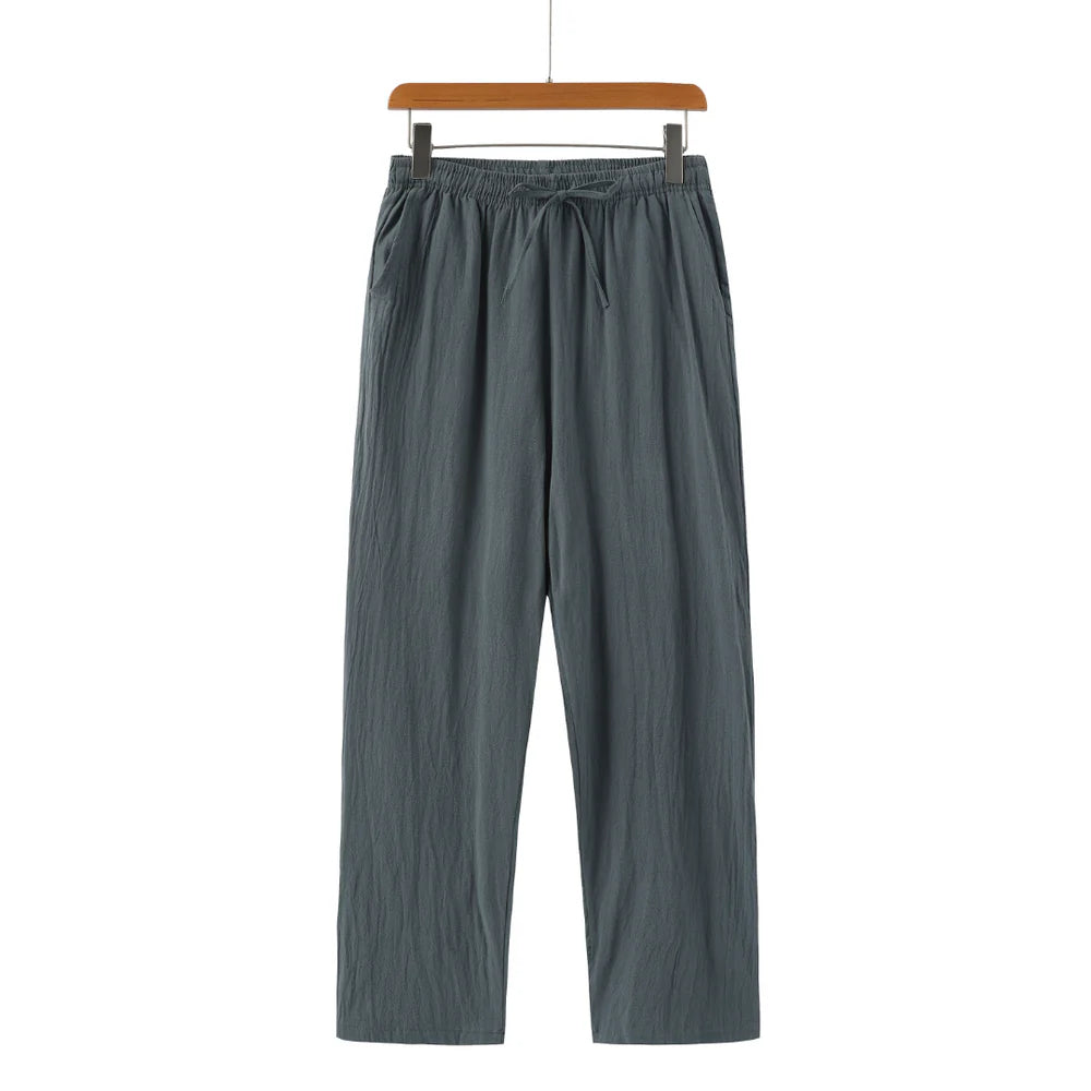 Gray pants on a hanger against a white background