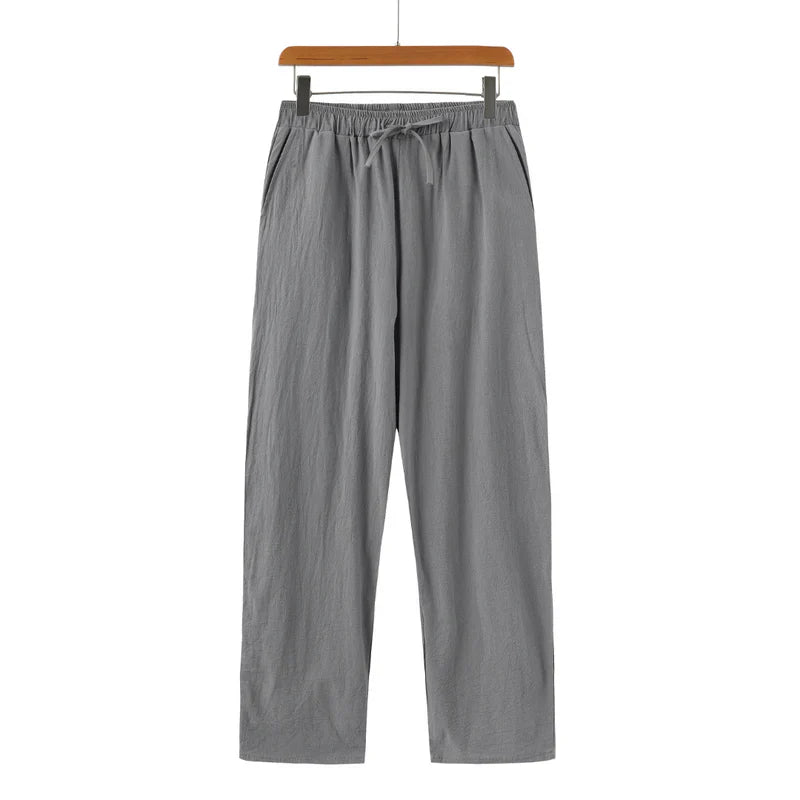 Gray pants on a hanger against a white background
