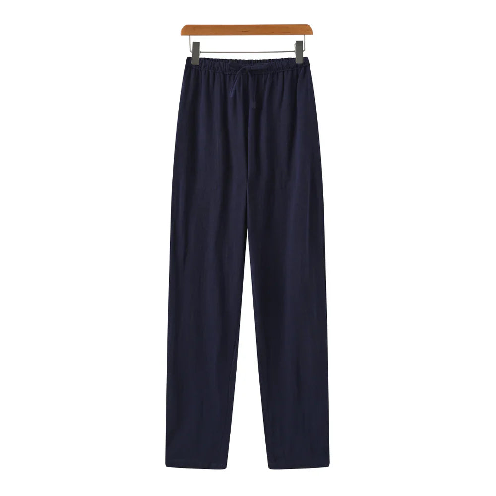 Navy blue pants on a hanger against a white background