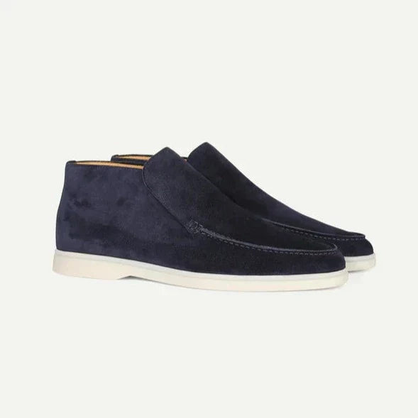 Pair of navy blue suede shoes on a white background