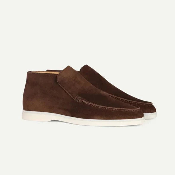 Pair of brown suede shoes on a white background